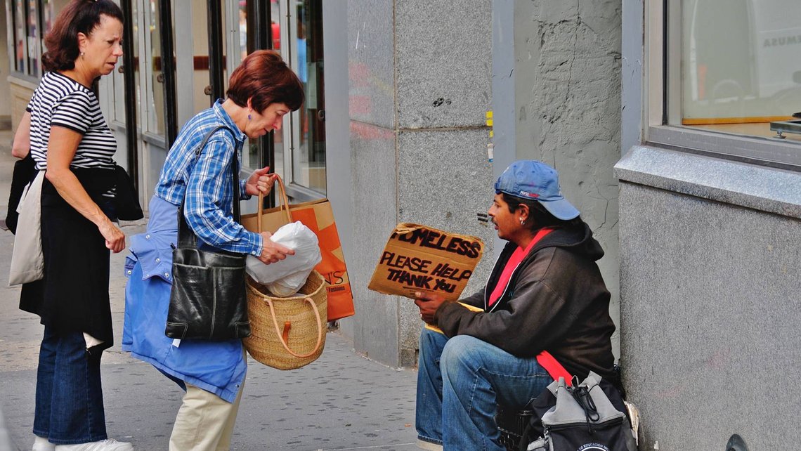 People helping homeless man.